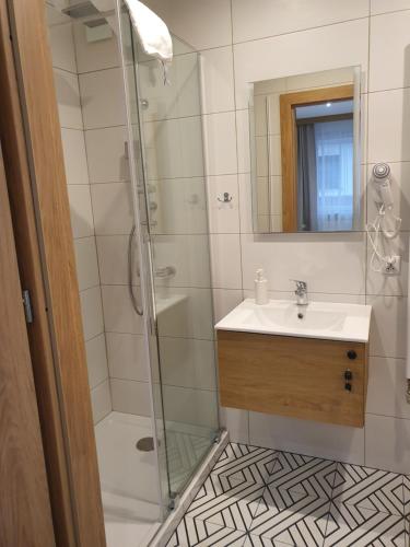 a bathroom with a shower and a sink at Pokoje gościnne vis a vis Retro in Gostynin