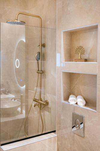 a shower with a glass door in a bathroom at Zen Garden Villa in Theológos