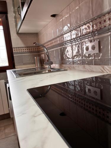 a kitchen with a sink and a counter at Los Ayales in Huelamos