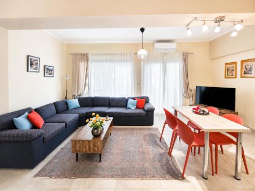 a living room with a blue couch and a table at Elena's nest in Kastoria