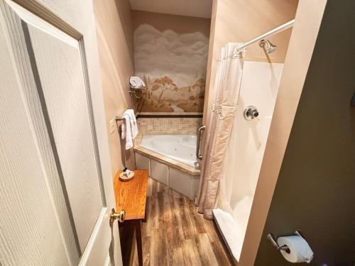 a small bathroom with a tub and a shower at The Barn Inn Bed and Breakfast in Millersburg