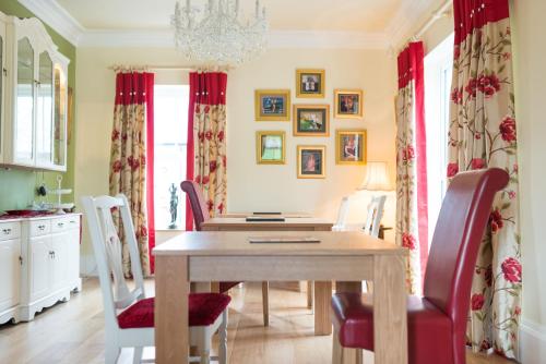 a dining room with a wooden table and chairs at Ashbrook House B&B in Aughnacloy