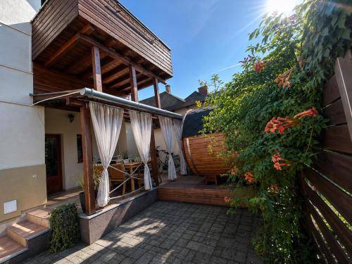 a house with a patio and a fence at Dora Holiday House & Apartments -Sauna & Relax by the Lake in Keszthely