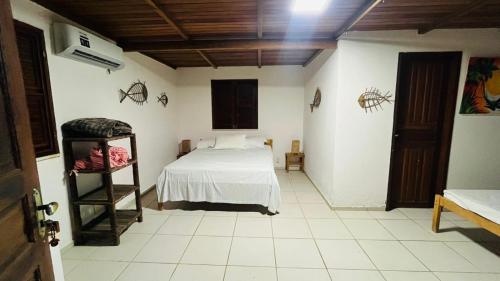 a bedroom with a bed and a ladder in it at Pousada Maraí in Amontada