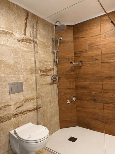 a bathroom with a toilet and a glass shower at Hotel Bosna Banja Luka in Banja Luka