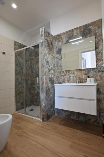 a bathroom with a shower and a sink and a mirror at Villa Grazia in Oliveto Citra