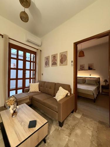 a living room with a couch and a table at Petalidi seaside Retreat in Petalidi