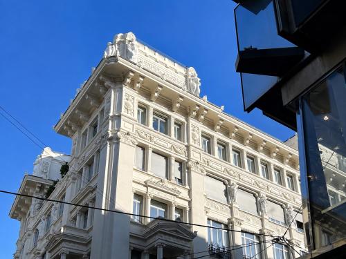 a tall white building with a tower on top of it at FLATSHARING - SPADARI Duomo Suites in Milan