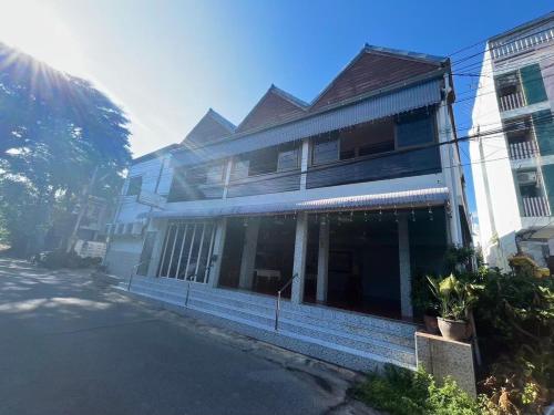 a large white building with windows on a street at SOLEIL HAUS - Huahin in Hua Hin