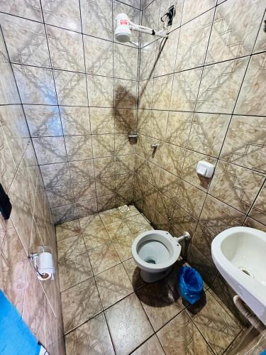 a small bathroom with a toilet and a sink at A2 suites Unid Sofia in Jataí