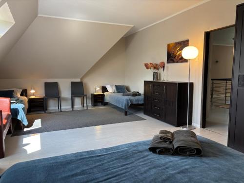 a bedroom with a bed and a living room at Jaunkrastmaļi in Kandava