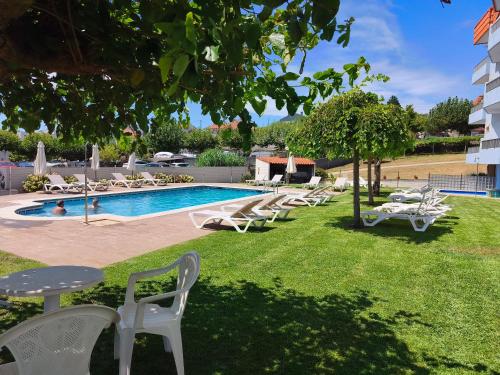 a resort with a pool and lounge chairs at Apartamentos Montalvo Playa in Montalvo