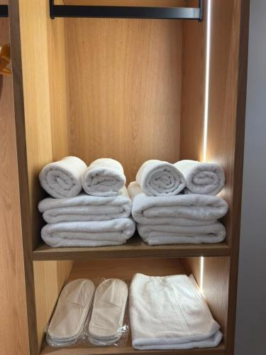 a bunch of towels are arranged in a closet at Airport Gate Hotel in Rinas