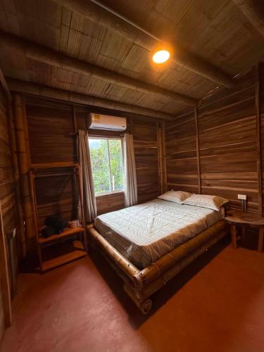 a bedroom with a bed in a room with a window at Greengoat Haven in Santa Marta