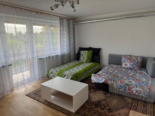 a living room with a bed and a table at Cosy accommodation in Dańce