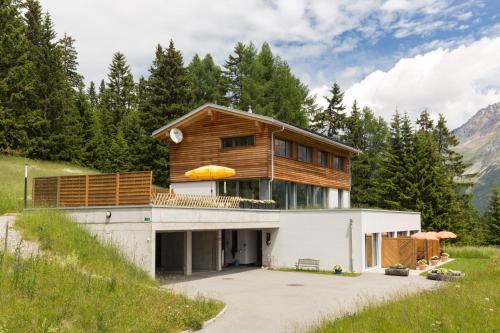 a house on the side of a mountain at Bed and Breakfast Raschainas Lenzerheide in Sporz