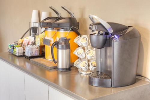 a counter with a coffee maker and other kitchen items at Steam Plant Hotel in Spokane