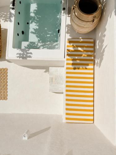 a view of a table with a vase and a drawer at THE HILL Suite in Ialysos