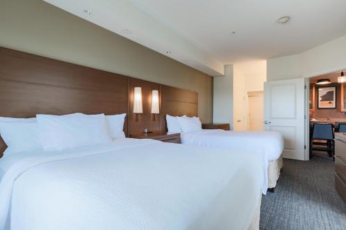 a hotel room with two beds and a desk at Residence Inn by Marriott Helena in Helena