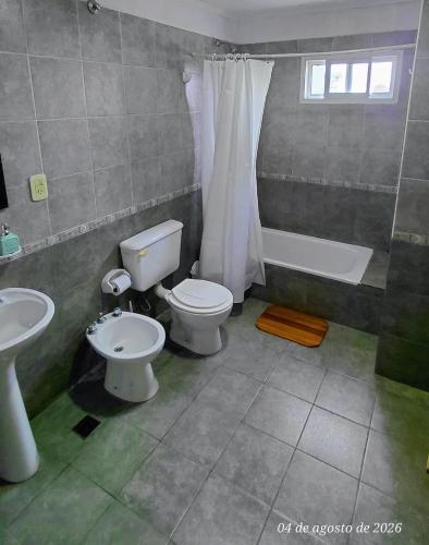a bathroom with a toilet and a tub and a sink at Ayalata del Rio in Colón
