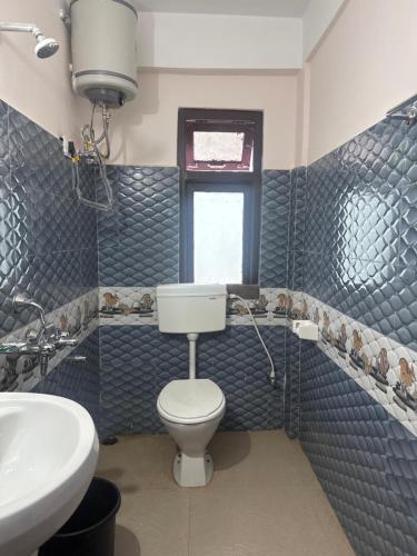 a bathroom with a toilet and a sink at The Mirik Address in Mirik