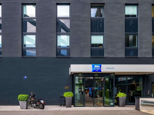 a motorcycle parked in front of a building at ibis budget Hamburg City in Hamburg