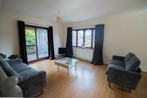 a living room with two couches and a coffee table at The Welsh Hideaway in Llanberis