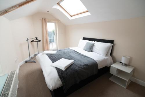a bedroom with a large bed and a window at The Welsh Welcome in Pen-y-groes
