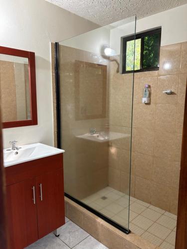 a bathroom with a shower and a sink at Beach House EL Cocalito in La Libertad