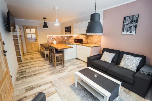 a living room with a couch and a table at Pension Linda in Harrachov