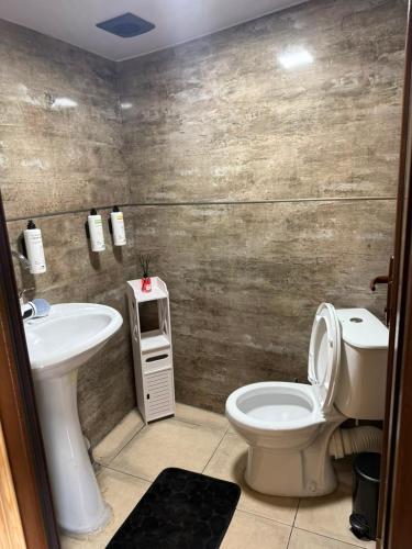 a bathroom with a toilet and a sink at Guesthouse Mountain House in Khalde