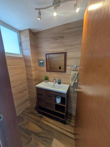 a bathroom with a sink and a mirror at Casa Terraza Zacatlan in Zacatlán