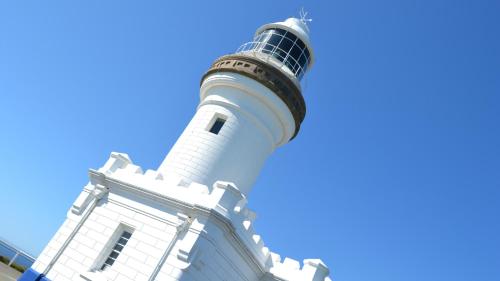 a lighthouse on top of a white building at Lily Pad at Byron Bay in Byron Bay