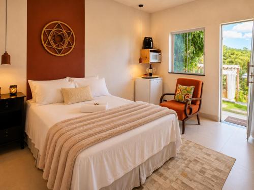 a bedroom with a bed with a laptop on it at Villa Pella - Chalé Rosa- hidro e café manhã in Brumadinho