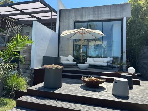 a patio with a table with an umbrella at Phegans Bay Waterfront Haven in Blackwall