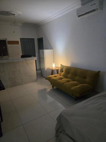 a living room with a couch and a kitchen at Le gite 1 in Libreville