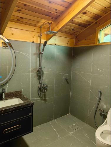 a bathroom with a shower and a sink at اكواخ لاكجري ابها 2 in Abha