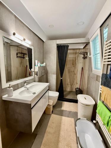 a bathroom with a sink and a toilet at Villa Kadeli 