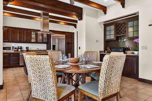 a dining room with a wooden table and chairs at Resort Villa Pool Golf & Beach Access in Playa Avellana