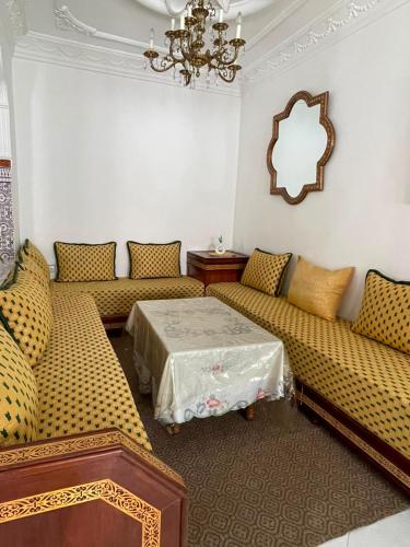 a living room with couches and a table at Casa Amina in Martil