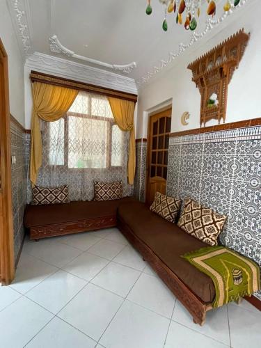 a large bed in a room with a window at Casa Amina in Martil