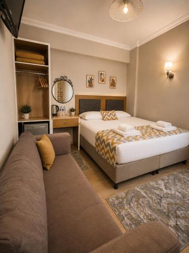 a bedroom with a bed and a couch at Kestanbol Hotel in Çanakkale
