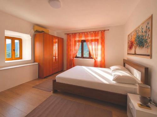 a bedroom with a large bed and a window at Water Lily Dock Prevlaka in Prevlaka