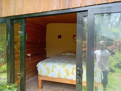 a person taking a picture of a bed in a glass house at Island Breeze in Negril