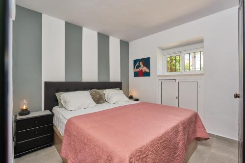 a bedroom with a bed with a pink blanket at Casita Helena in Torrox