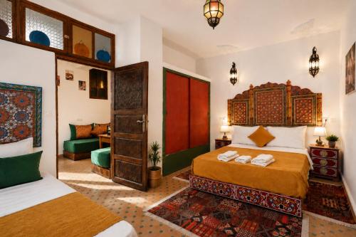 a bedroom with a bed and a living room at Dar Houda in Fez