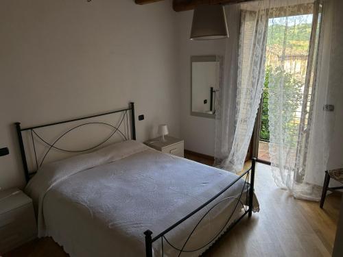 a bedroom with a bed and a large window at Sibillini Dream House in Amandola