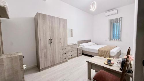 a bedroom with a bed and a cabinet and a table at Zvartnoc siti star in Pʼarakʼar