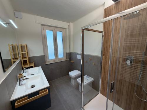 a bathroom with a toilet and a sink and a shower at Casa Arianna in Lido di Camaiore
