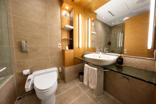 a bathroom with a toilet and a sink at Daegu Grand Hotel in Daegu